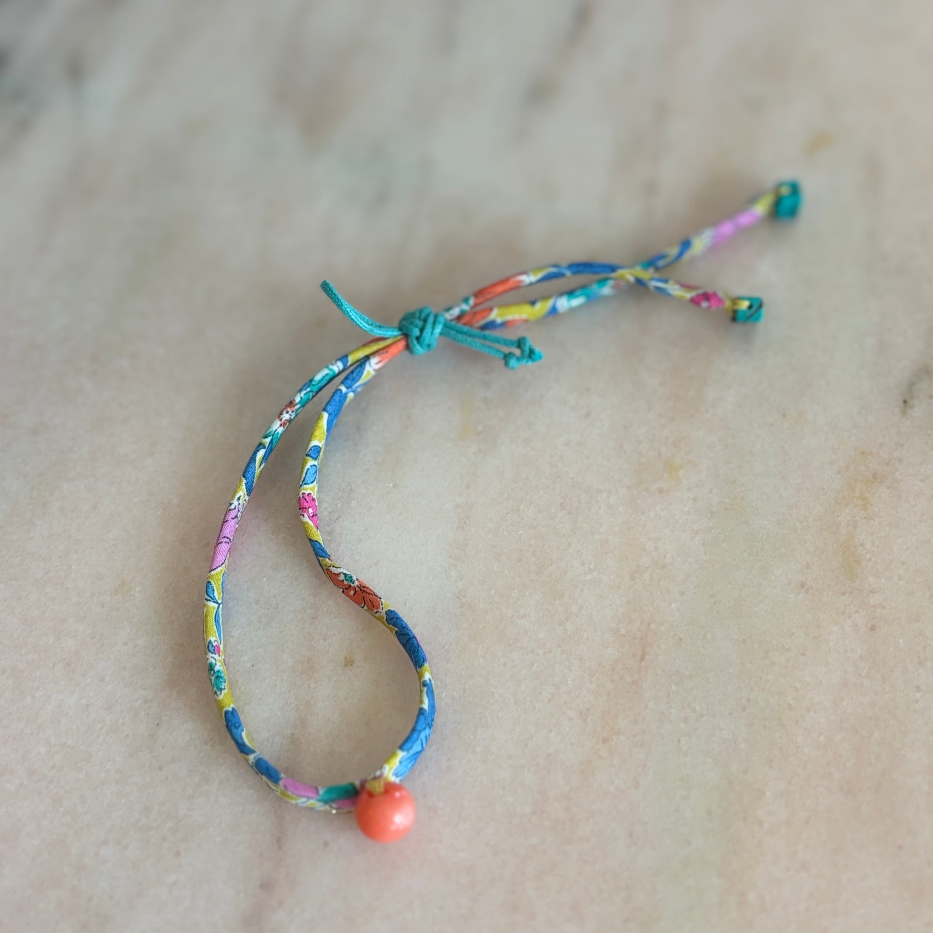 Side view of Wild-Flowers Liberty Bracelet showing floral cord and green sliding button by Boussidan