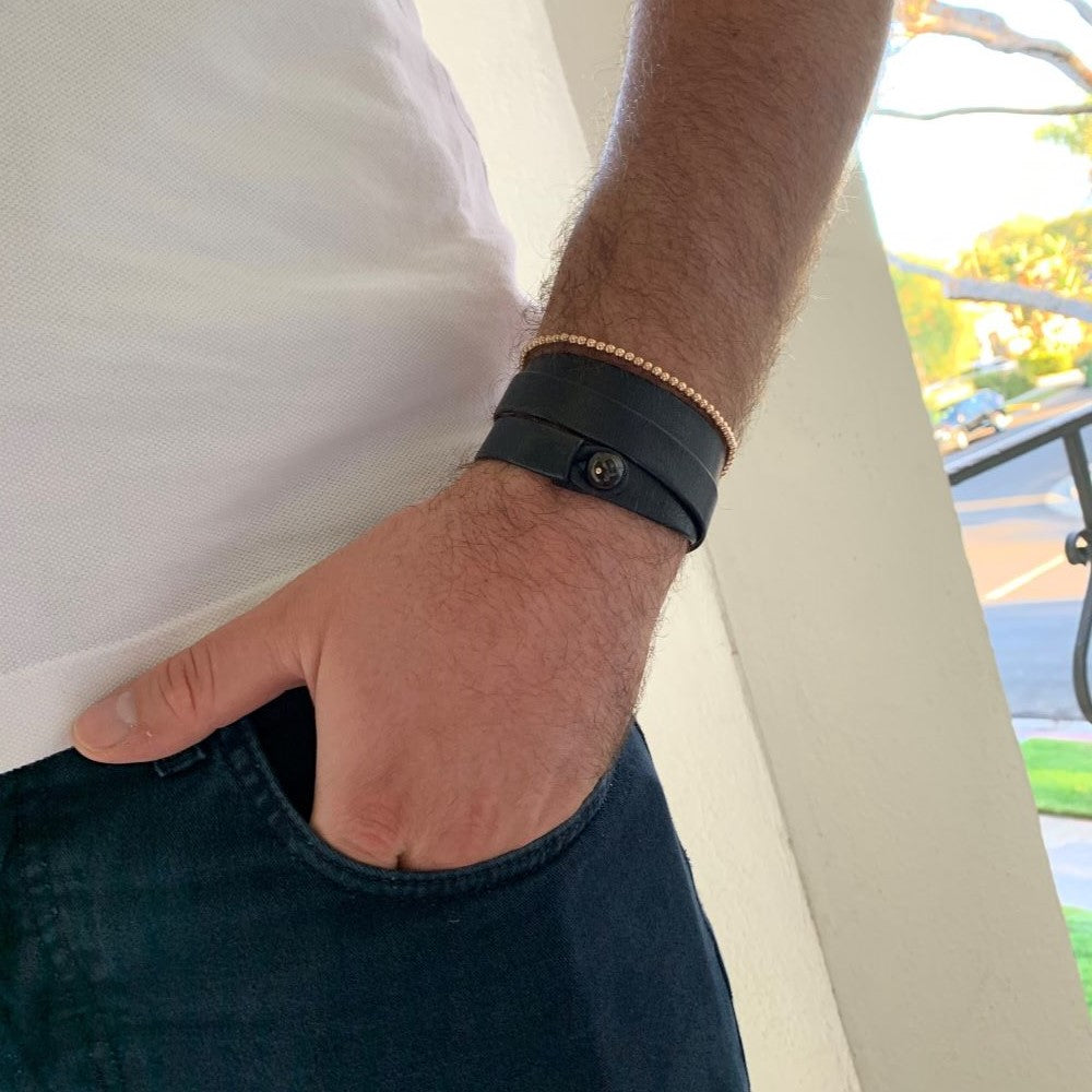 The Falcon triple wrap leather bracelet on wrist, showcasing unisex luxury