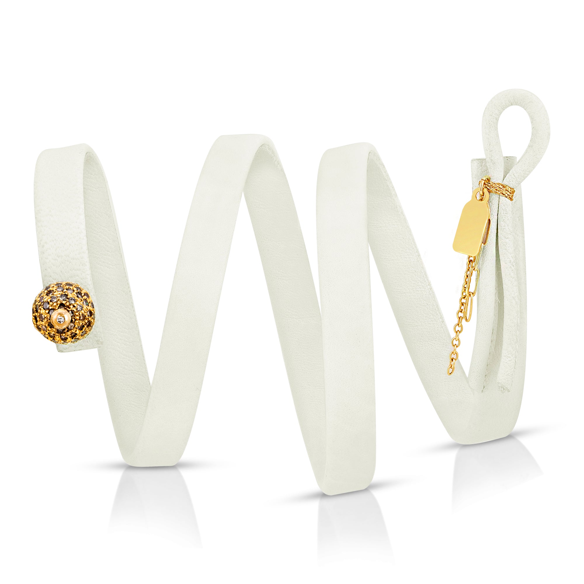 Close-up of 14k gold diamond ball with diamond-encrusted pin on The Regente leather bracelet