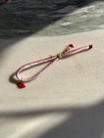 Load image into Gallery viewer, Red lips enamel charm pink silk bracelet adjustable gold cord button red spinel gold thread 
