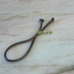Load image into Gallery viewer, Handmade ombre silk bracelet with black pearls and gold braided button on silver thread
