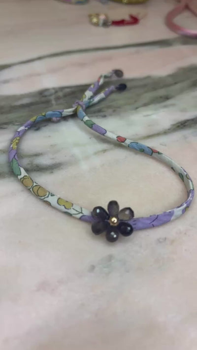 Video of Wild Orchid Wild-Flowers Liberty Bracelet showing floral cord, amethyst flower charm, and adjustable lavender button by Boussidan.