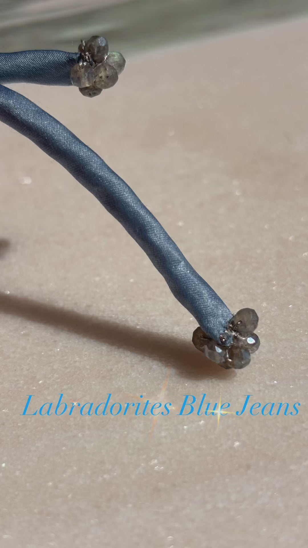 Video of Perfect blue jeans color silk bracelet labradorite center bead blue cord sliding button adjustable labradorites finishing beads silver thread by boussidan