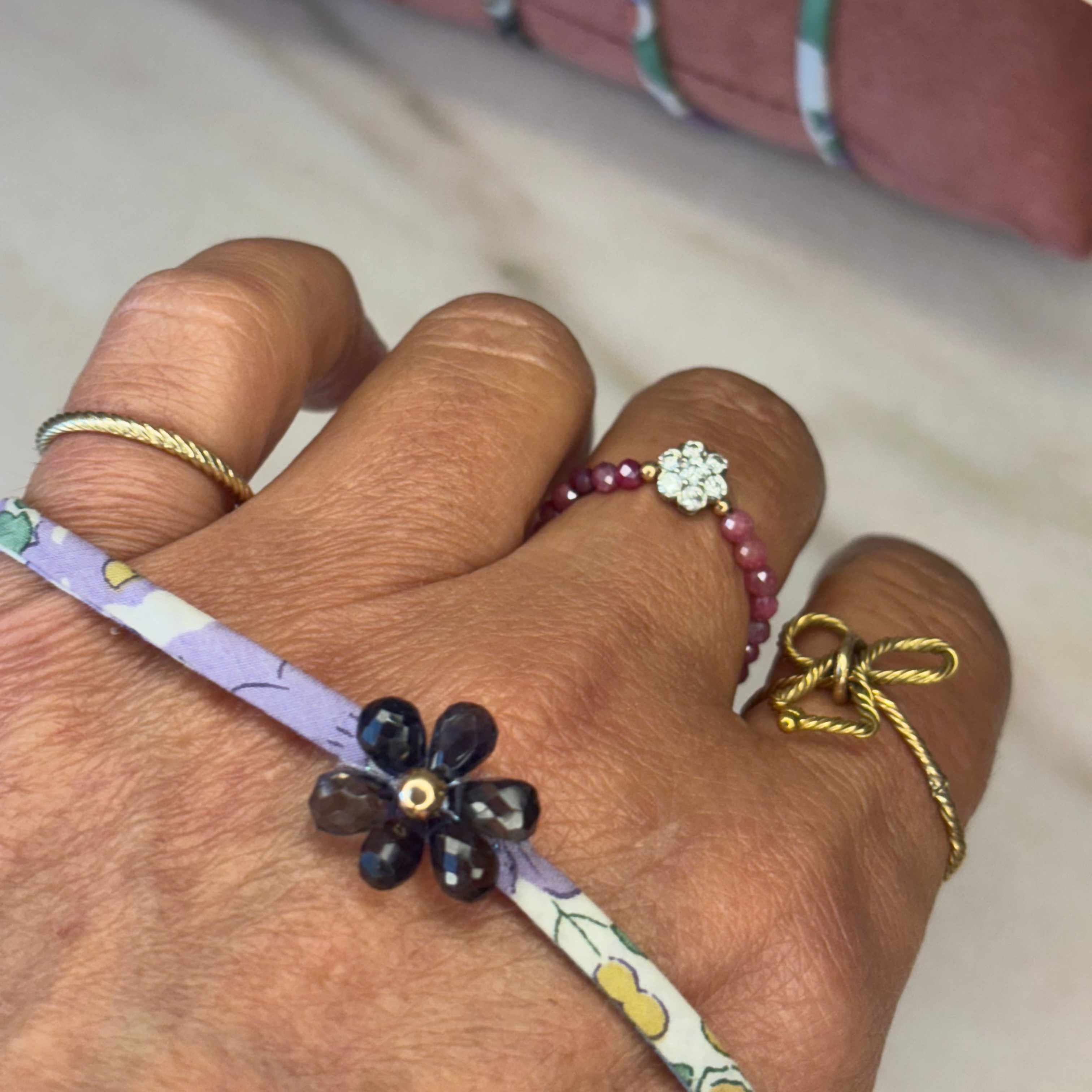 Close-up of Wild Orchid Wild-Flowers Liberty Bracelet detailing amethyst flower charm and drops by Boussidan.