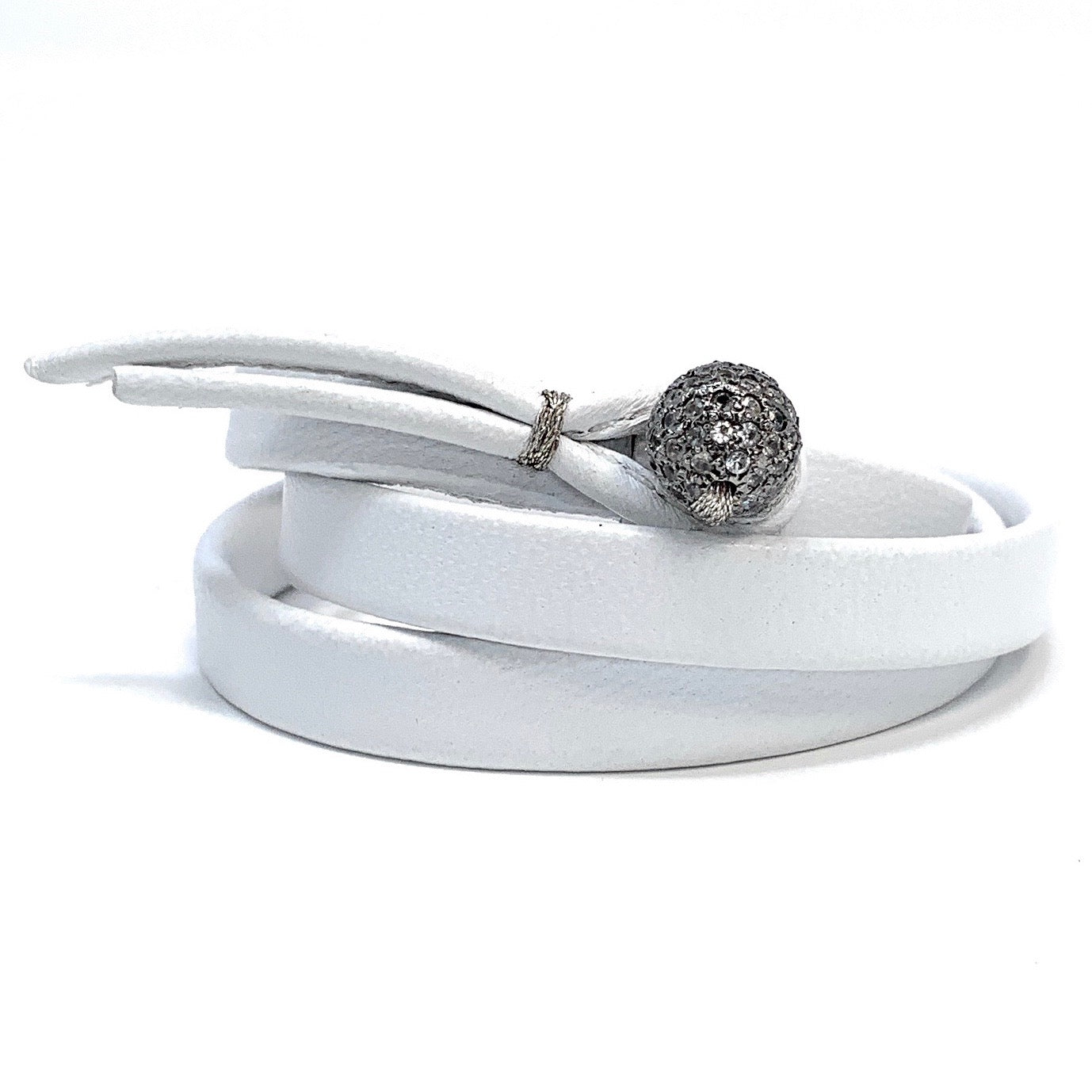Close-up of sterling silver white sapphire ball on The Azure leather bracelet
